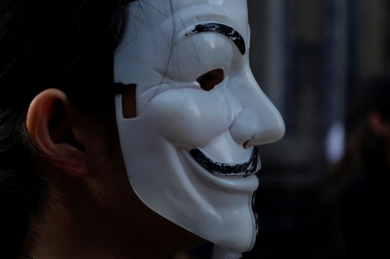 Unidentified hacker embarrasses spyware firms and remains at large
